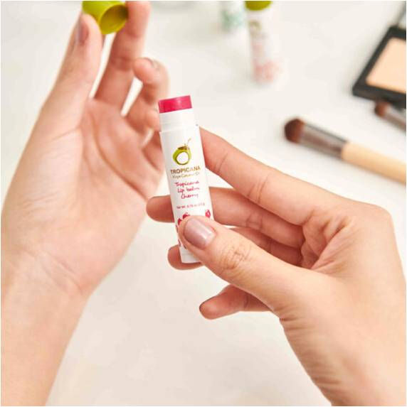 Hands holding INGON lip balm, with visible text. Chooasia.com for skincare