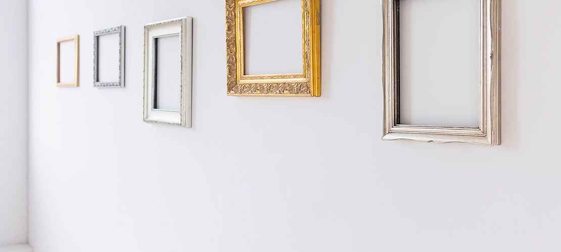 A group of empty frames on the wall