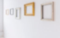 A group of empty frames on the wall