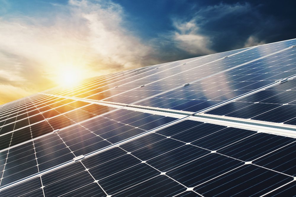 Solar panels with sun in the background