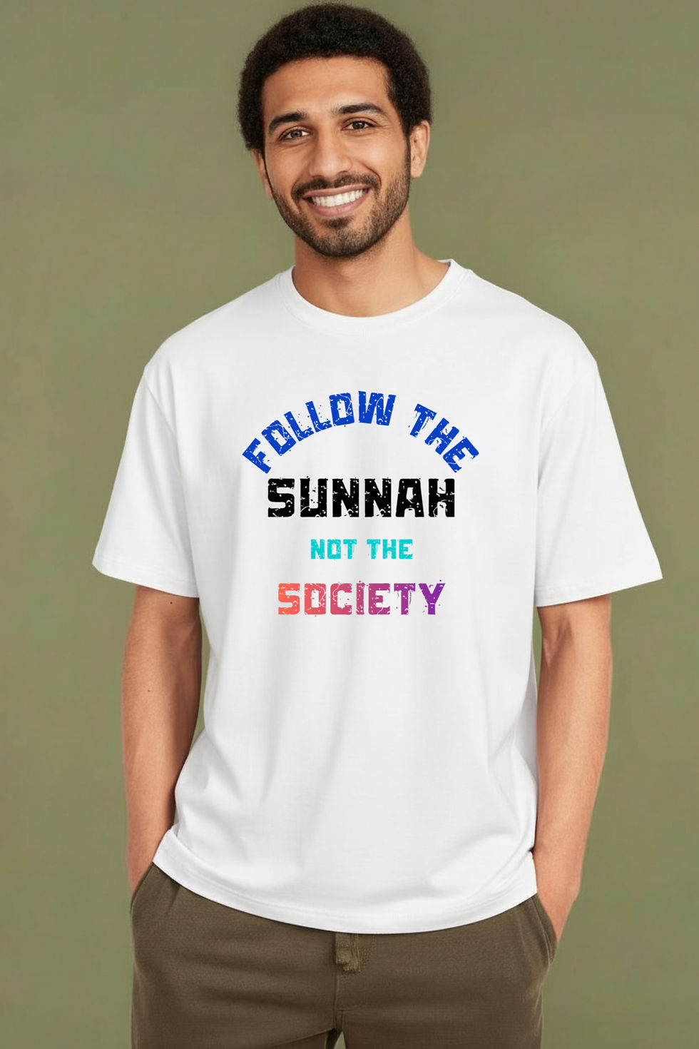 Smiling man wearing a white shirt with the text 'Follow the Sunnah'. 