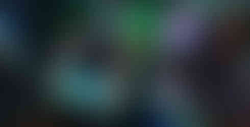 Multi-exposure image of artist and partner in dimly lit studio with brightly colored artworks