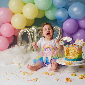 cakesmash with rainbow coloured balloons