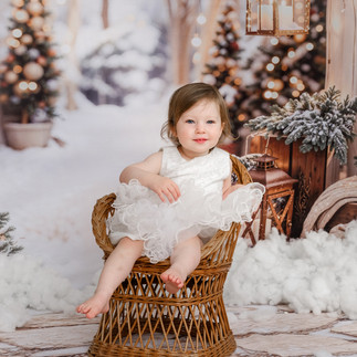 A heartwarming family moment during a Christmas 2025 photo session at Jo Buckley Photography’s studio in Tresprison Court, Helston, Cornwall, surrounded by festive holiday decor.