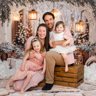 A heartwarming family moment during a Christmas 2025 photo session at Jo Buckley Photography’s studio in Tresprison Court, Helston, Cornwall, surrounded by festive holiday decor.
