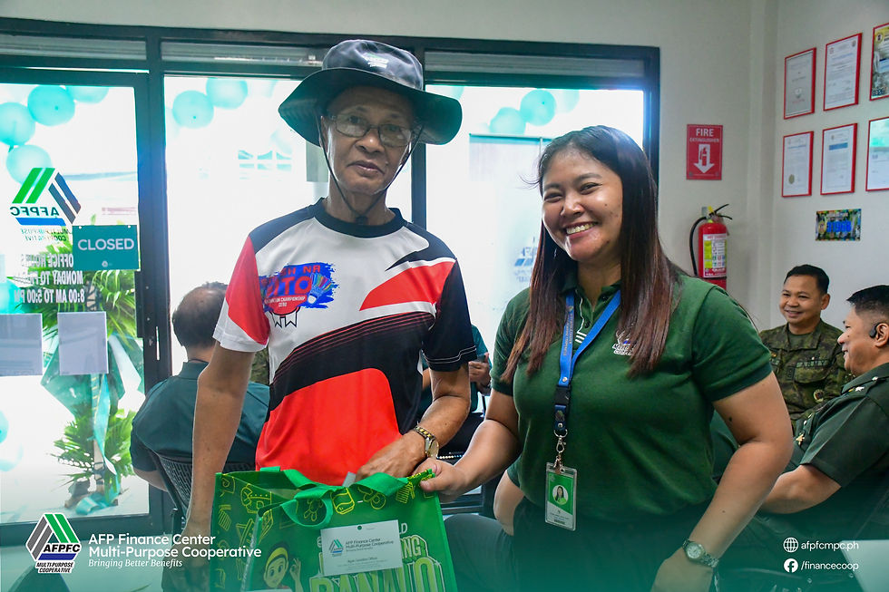 An Iliganon Kamay-Ari receives bonus giveaways as an incentive for availing a loan during the welcome promo of the AFPFC MPC Iligan Satellite Office.