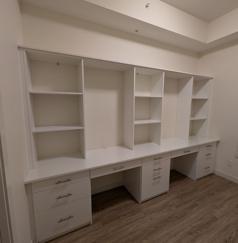 Large white custom built-in dual desk for two people.