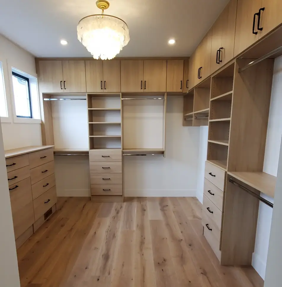 Light wood custom shelves and hanging rods.