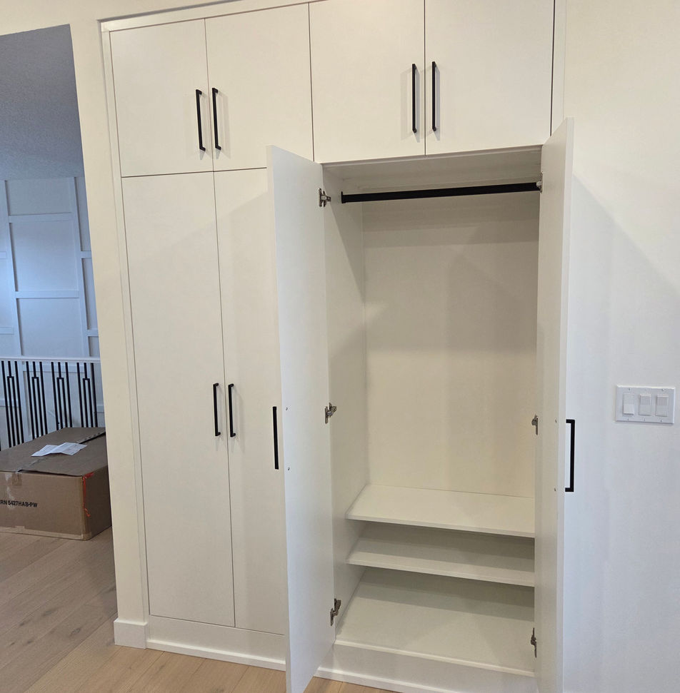White custom cabinet built into a wall niche.