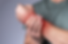 A man holding his left wrist because of wrist pain