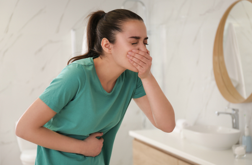 Young woman suffering from severe nausea and vomiting