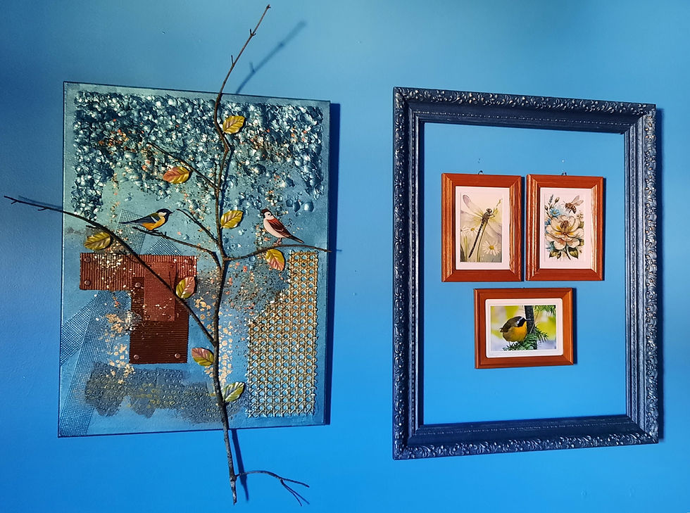 Art on blue wall: left, collage with birds, branches, and texture; right, three framed prints of a dragonfly, flower, and bird.