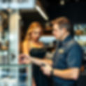 Locksmith shop, Man in locksmith uniform helping beautiful women wearing a dress look at