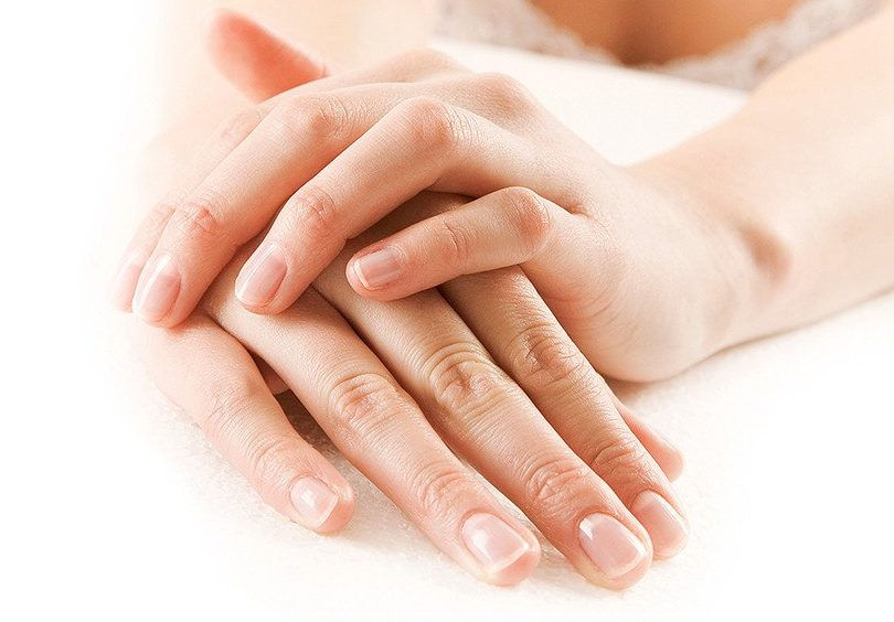 Clasped hands with natural, healthy nails