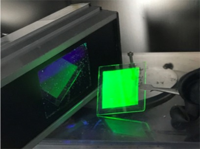 A low-cost and solution-processed perovskite film shows bright green emission under UV lamp excitation @ Kyushu University/Adachi Lab