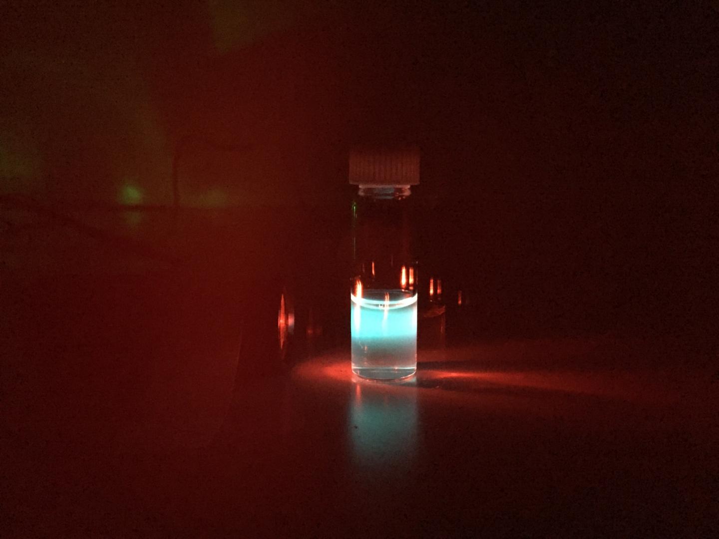 Organic nanoparticles in a vial convert invisible near-infrared light to intense blue light, which can easily be seen by human eyes. @ Gang Han