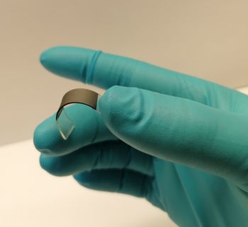 A Sussex researcher holds a self-adhering medical patch made from scalably printed graphene layer on rubber @ University of Sussex