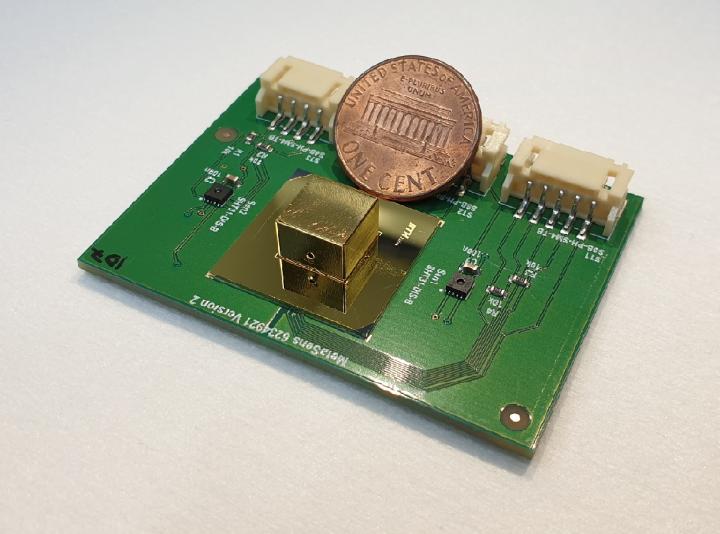 The miniature all-metamaterial optical gas sensor (golden capsule) next to a one-cent coin. @ Alexander Lochbaum, ETH Zurich