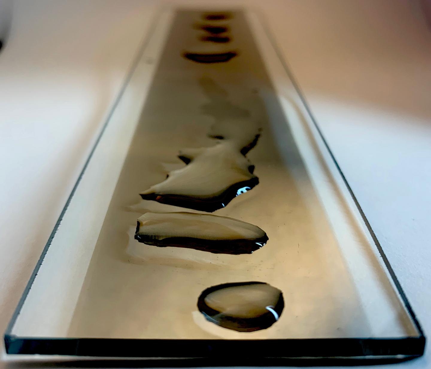 Water drops on metal nanolayer. Northwestern University and Caltech scientists have produced electricity by flowing water over extremely thin layers of inexpensive metals that have oxidized. @ Franz Geiger, Northwestern University