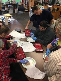 Scribe Lucas Short helps lead a dissection activity with Phoenix School/Roseburg High School Students.