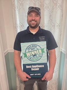 owner holding best appliance repair plaque