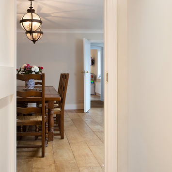 Interior view with dining table and chairs, hardwood floor, light fixtures