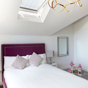 Bedroom with bed, pillows, mirror, skylight, and decorative lights. My Site 4