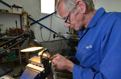 tool-maker-working-on-brass-component.jp