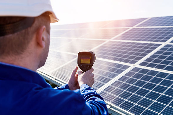 Inspector examination of photovoltaic modules using a thermal imaging camera.jpg