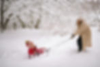 mom-pulling-child-on-sled.jpg