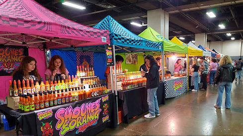 I_Heart_Beer_10_hot_sauce_vendors_lined_up_at_a_hot_sauce_marketplace,_indoors_8c37a1e8-f9