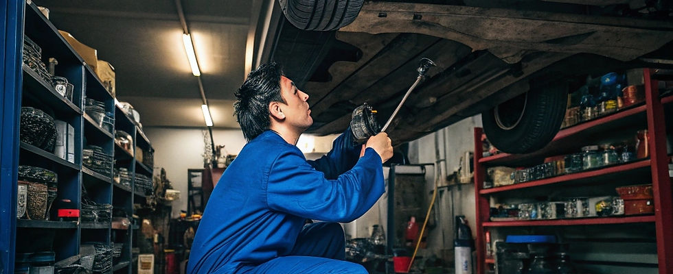 a-mechanic-is-fixing-a-car-in-a-garage-.jpg