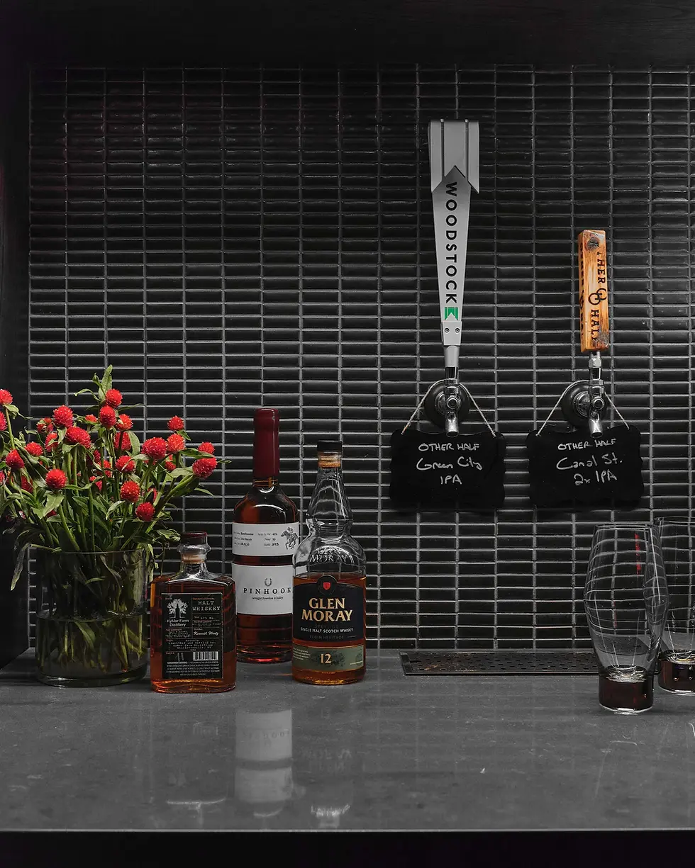 Custom home bar with beer taps and bronze tile backsplash