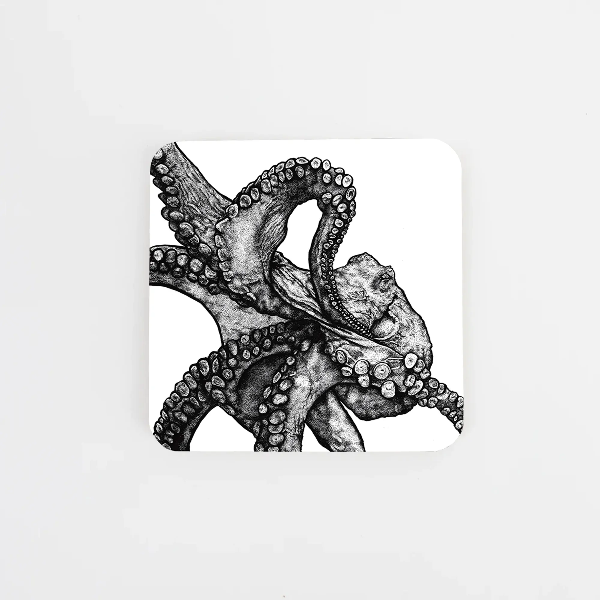 Melamine coaster with a print of a hand-drawn illustrated octopus in black and white.
