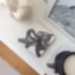 Melamine coasters with a print of a hand-drawn illustrated octopus in black and white.