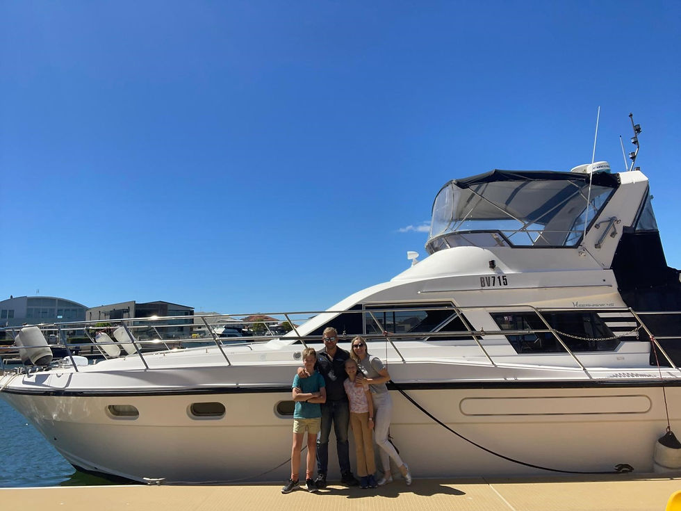 family standing in front of the Seahawk 45 before a full boat refit