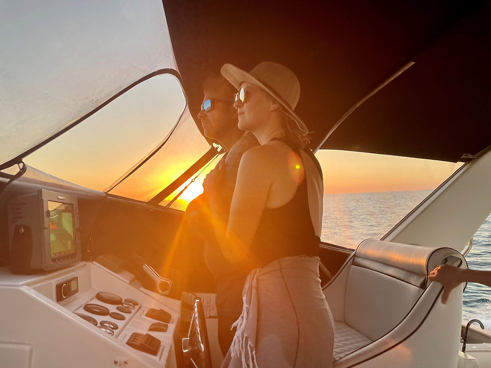 couple at sunset at the helm before starting a full boat refit