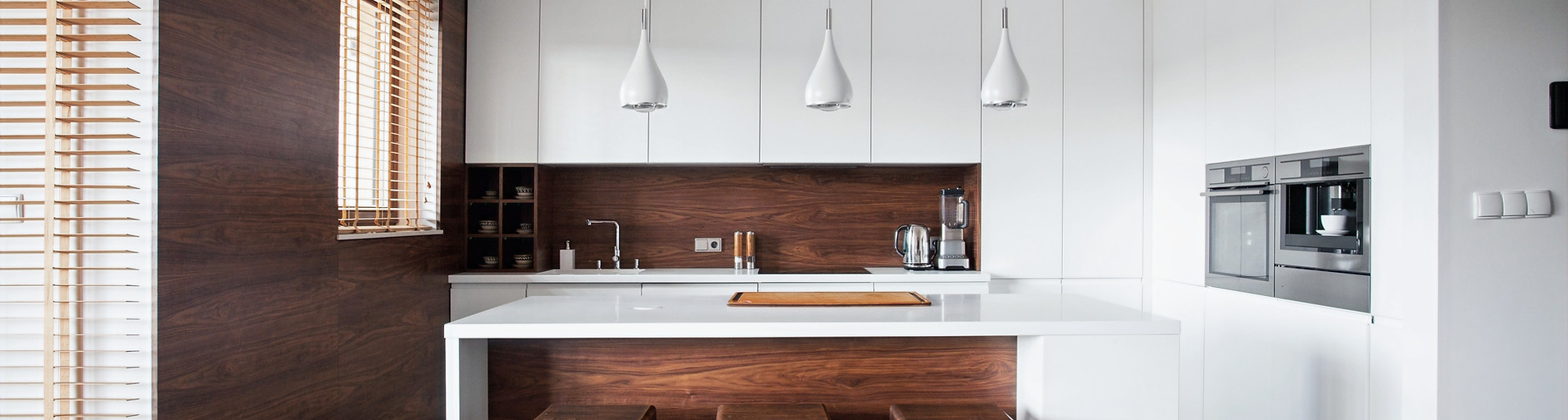 Modern kitchen with pendant lighting over island bench