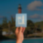 White vinyl decal featuring the Jupiter Inlet Lighthouse and palm tree silhouette