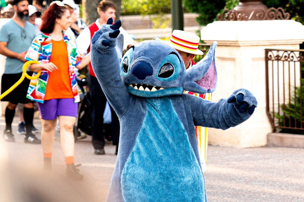 Stitch in costume walking Magic Kingdom parade at Disney World