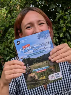 Leicestershire and rutland wildlife trust Market Harborough Nature Leaflet. Lauren Hulbert holding the nature restoration leaflet she designed.