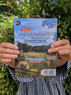 Leicestershire and rutland wildlife trust Market Harborough Nature Leaflet. Lauren Hulbert holding the nature restoration leaflet she designed.