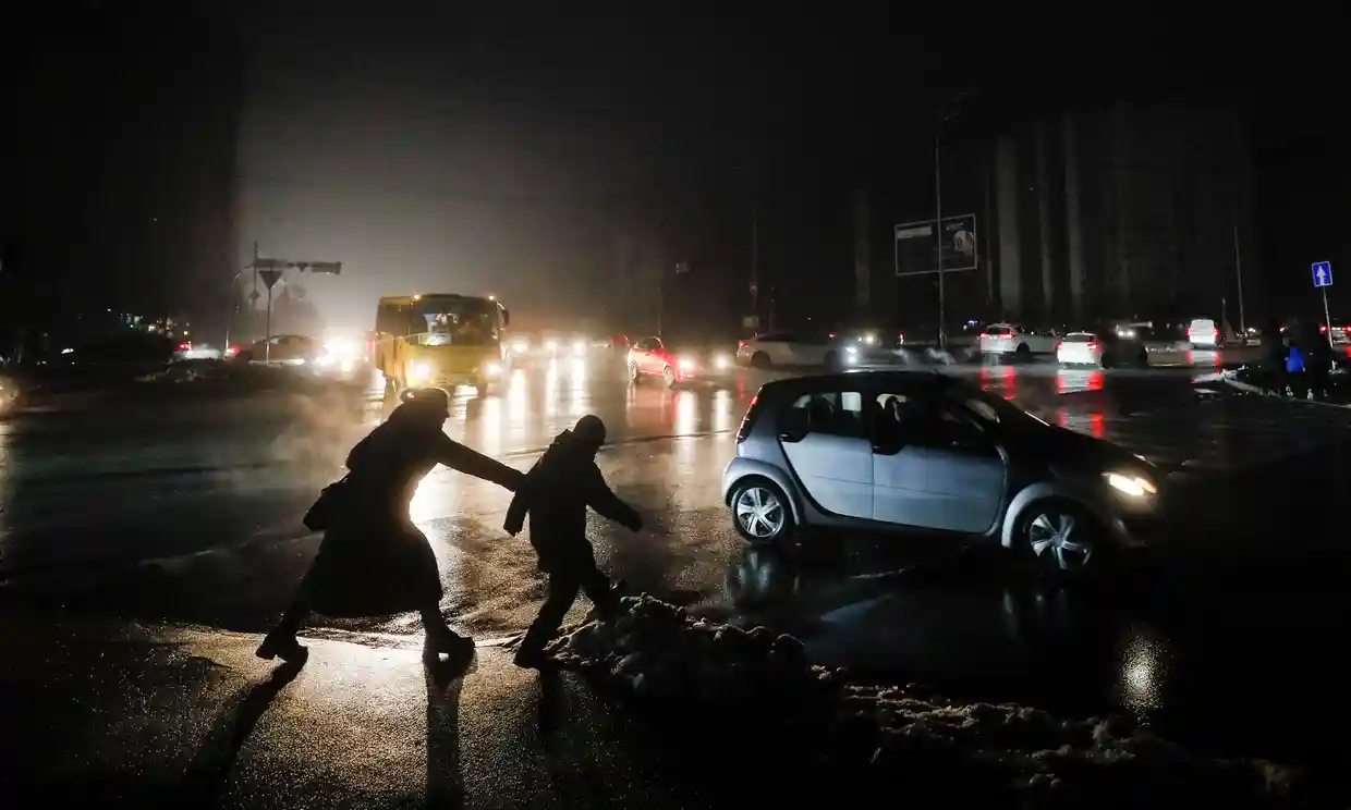 People cross a dark street in Kyiv on Thursday. Photograph Sergey Dolzhenko-EPA.webp