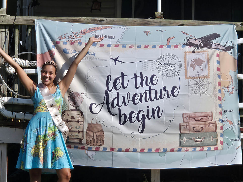 Arilyn, female wearing a globe dress beside a banner