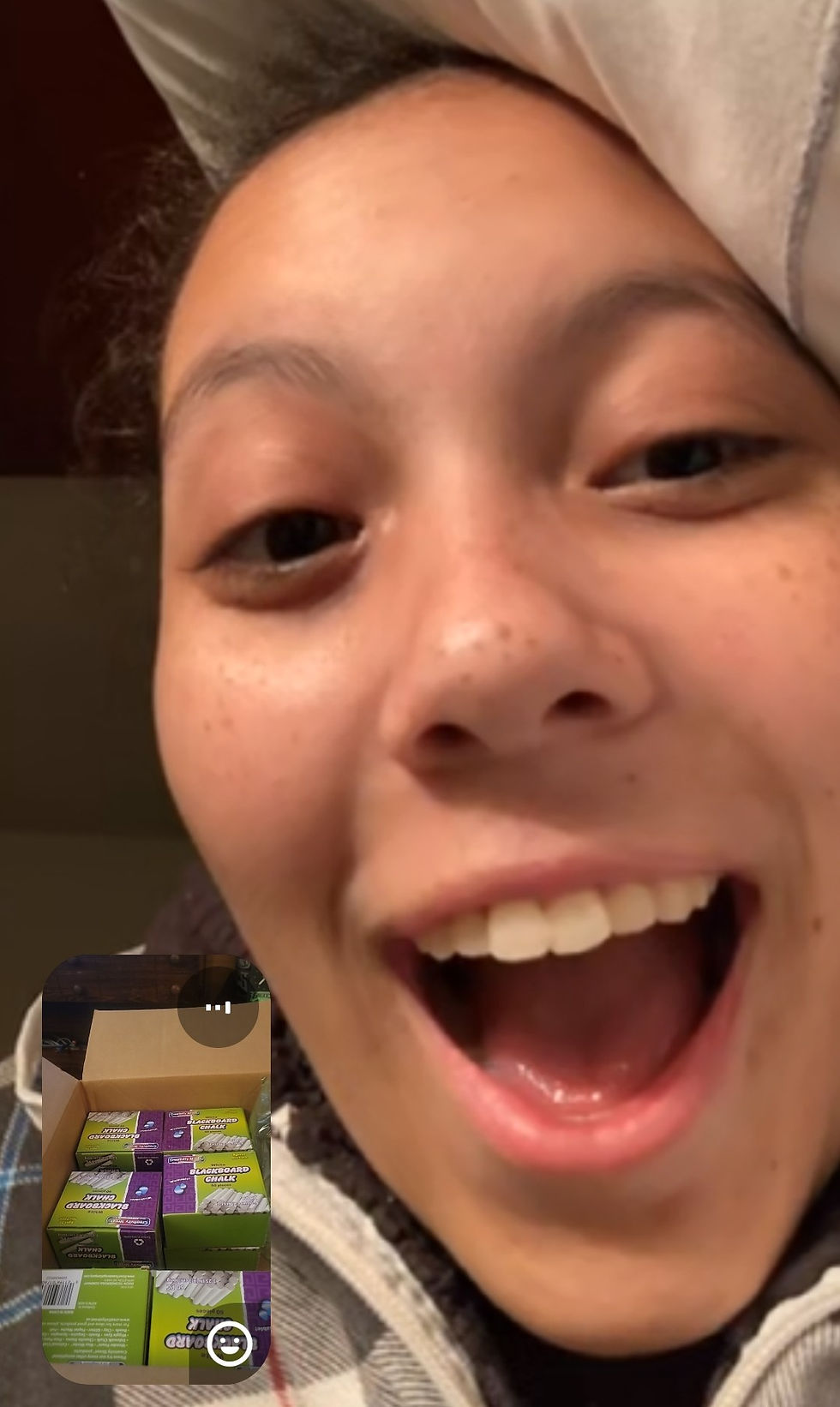 Screenshot of video call with Arilyn Oatman and the box of school supplies