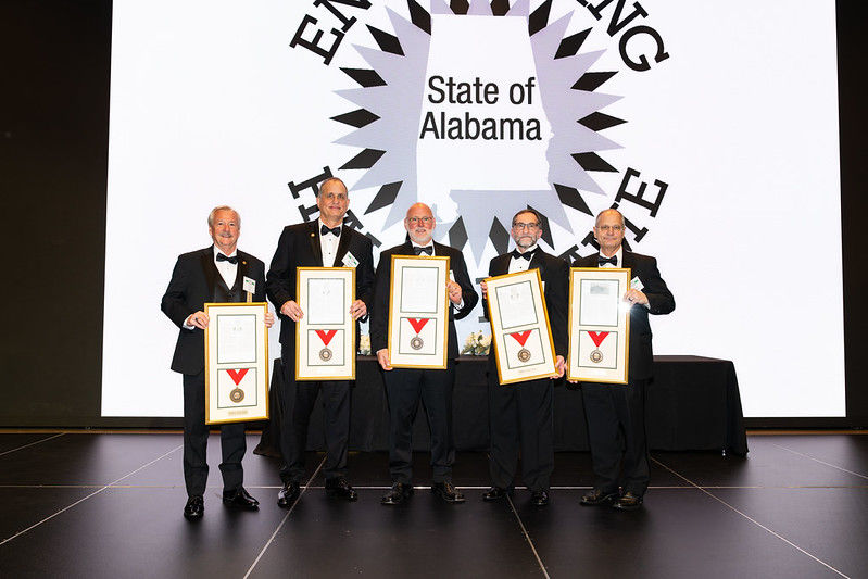 Five honorees holding framed engineering awards