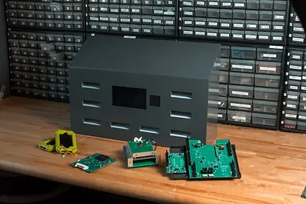 Eye-level view of an automated charging station with multiple device slots inside a correctional facility