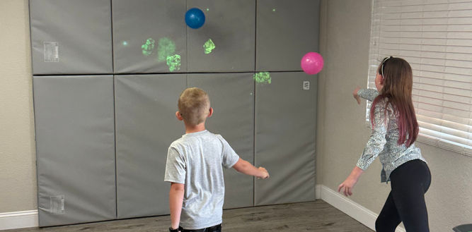 kids playing with game wall