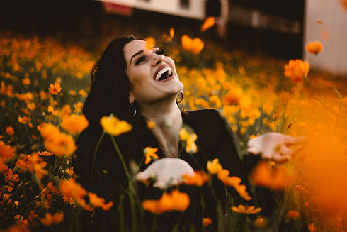Laughing woman in flower field.jpg