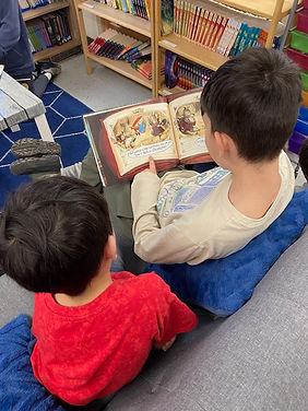 Two students reading a book